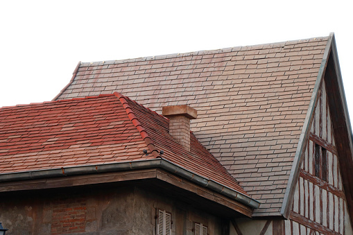 Old and new terracotta rooftiles on a French roof.Similar image:
