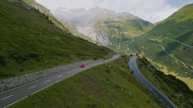 Aerial view of vintage car on the mountain road in Switzerland, Maloja Pass