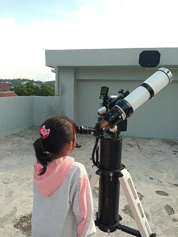 An astronomical telescope is a device that allows for the magnification and viewing of distant objects, such as planets and stars. It's an optical instrument that works on the principle of optics to view the enlarged image of heavenly bodies like stars and galaxies.