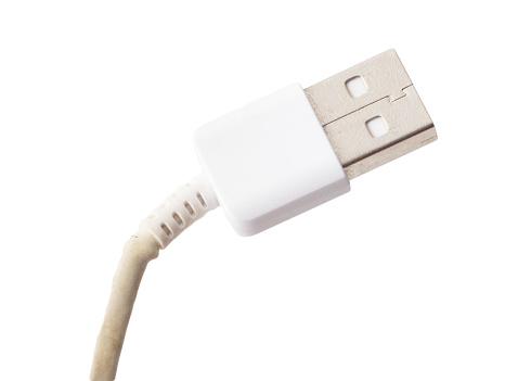 Broken cord on USB plug isolated on white background. Macro.