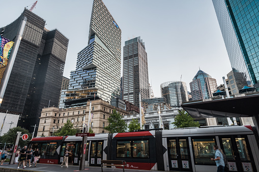 Sydney, NSW, Australia, February 17th 2024. A tram at a city stop with modern skyscrapers rising in the background.
