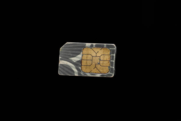 istock sim card isolated on black background, cellular chip card on black background 2026998637