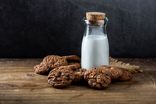 cookies and milk on wooden background