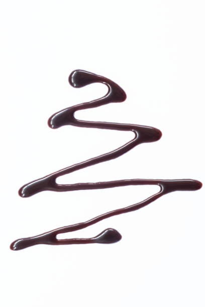 istock melted chocolate sauce isolated on white background 2027048114