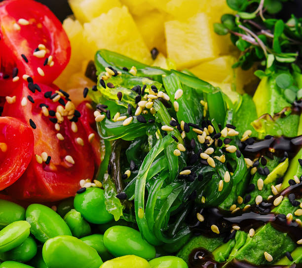 istock bowl with seaweed, beans, avocado and pineapple 2027059151