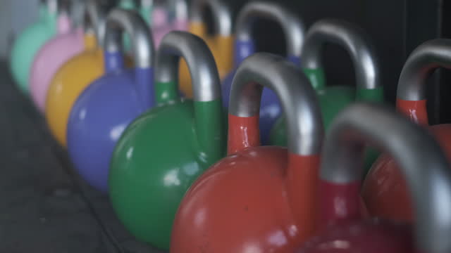 Group of Colorful Kettlebells at Gym