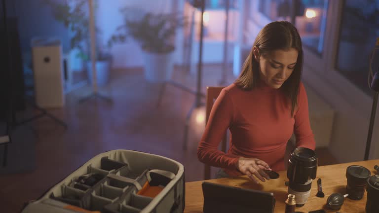 Woman cleaning photographic equipment