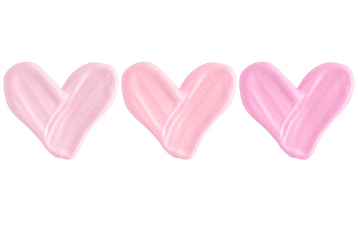 Set of hearts from liquid lipstick in pink and lavender pastel colours isolated on white background. Lipstick smear smudge texture different hue colors isolated on white background.