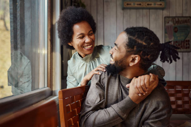 istock Happy black couple talking by the window at home. 2027097854