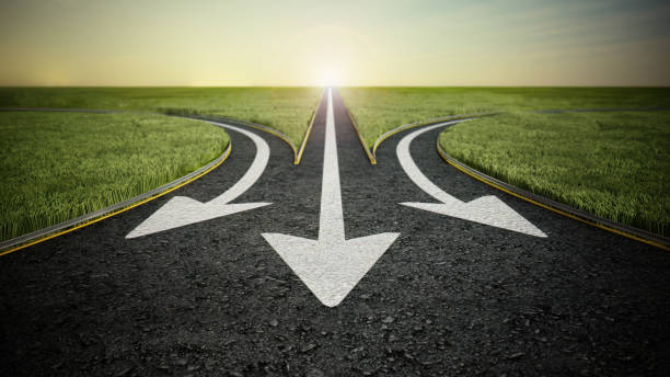 istock Three arrow signs on asphalt road pointing different ways. Choice and decisions concept 2027106294