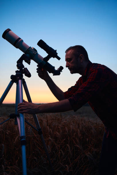 istock Astronomer looking at night sky with a telescope. 2027109457