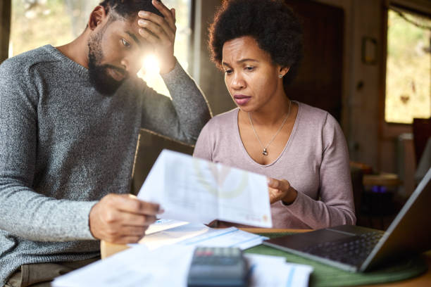 istock Worried black couple having problems with their financial bills at home. 2027110493