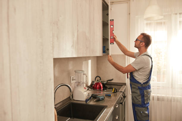 istock Handyman fixing kitchen cabinets in the apartment. 2027111546