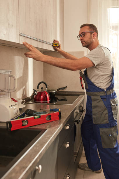 istock Handyman fixing kitchen cabinets in the apartment. 2027112061