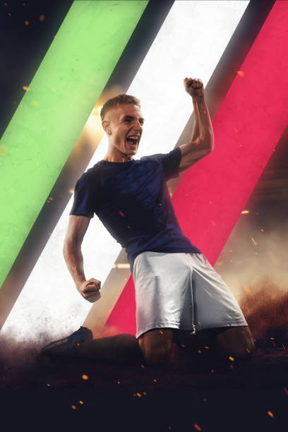 istock Competitive and motivated young guy, soccer player sitting on grass, showing winning pose, representing team of Italy 2027113654