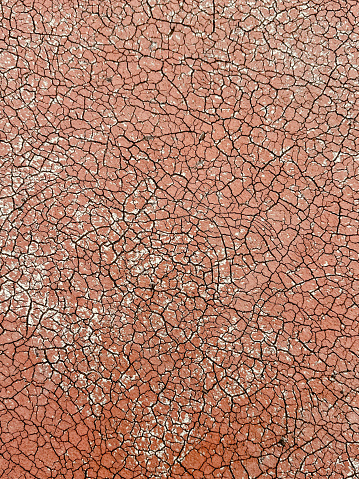 Old covering on a sports ground as an abstract background. Texture.