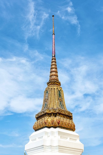 Phra Chedi Songkhrueang: one of four decorated stupas (or chedi, in Thai) beside the Phra Si Rattana Chedi at Wat Phra Kaew, the Temple of the Emerald Buddha with a white base, and spire decorated with 
gold leaf and glass tiles - Grand Palace, Bangkok, Thailand