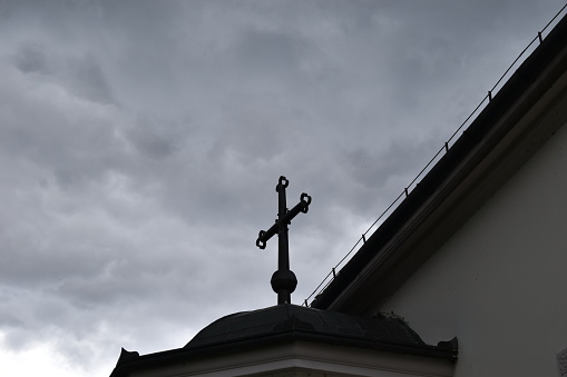 The iconic cross atop a historic church in Fruska Gora, a timeless symbol of spirituality and religious significance