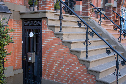 nyc, United States – February 08, 2024: An old brick house with stairs in New York, United States