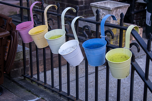 nyc, United States – February 08, 2024: The buckets hanging on a metal fence
