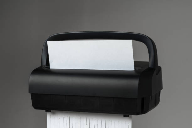 istock Black paper shredder cutting paper on gray background 2027187211