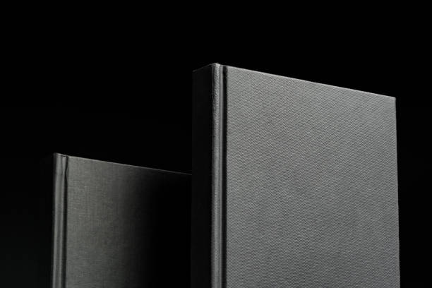 istock Black hardcover book or notepad mock up on black background 2027204111
