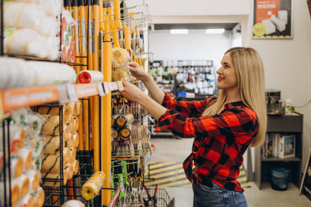 istock happy female customer shopping in hardware store. 2027224012