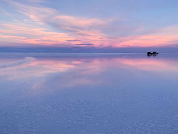 istock Beautiful sunset sky clouds blue pink above lake water 2027224545