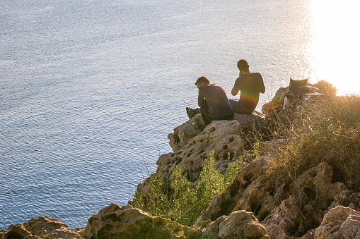 Antalya, Turkey - November 26, 2022: Unrecognizable people enjoying  serene ocean view by the cliff