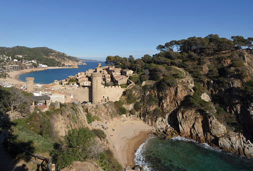 view of the medieval town of Tossa de Mar from the mountain near Cala es Codolar, in the background Gran beach, Girona province, Catalonia, Spai