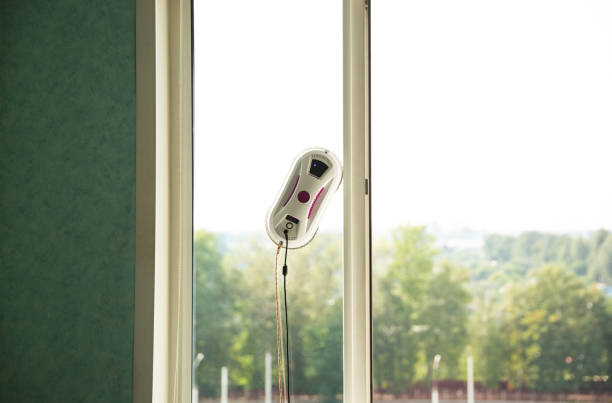 istock Vacuum automatic robot window cleaner cleans glass from dirt without human intervention and the risk of falling from a height. Window cleaning safety is top notch. Copy space for text 2027245749