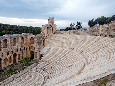 Odeon of Herodes Atticus at Acropolis, Athens, Greece. It is one of the top landmarks of Athens. Panorama of antique amphitheater. Scenic view of famous Ancient Greek ruins in the Athens center.