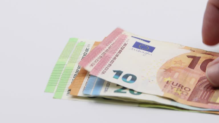 Putting on the white table banknotes of 100, 50, 20, 10 and 5 euros. White background