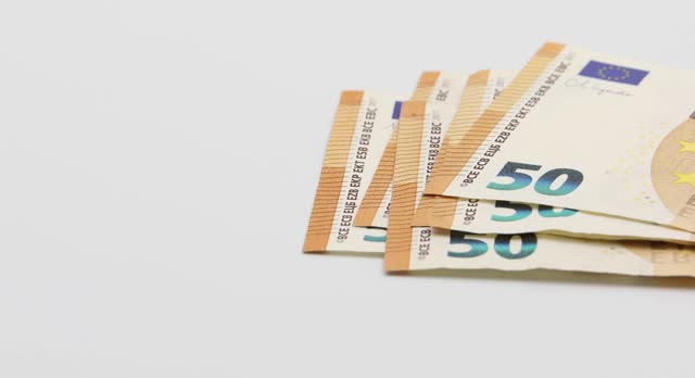 Putting on the white table banknotes of 50 euros. White background