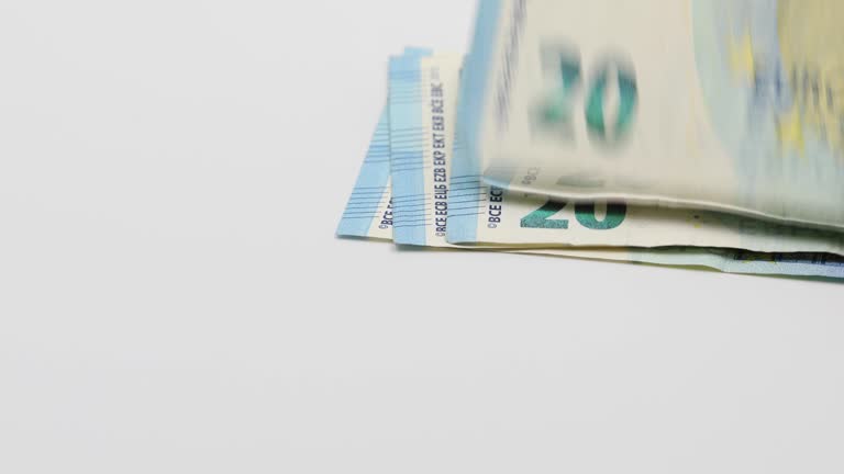 Putting on the white table banknotes of 20 euros. White background