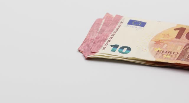Putting on the white table banknotes of 10 euros. White background