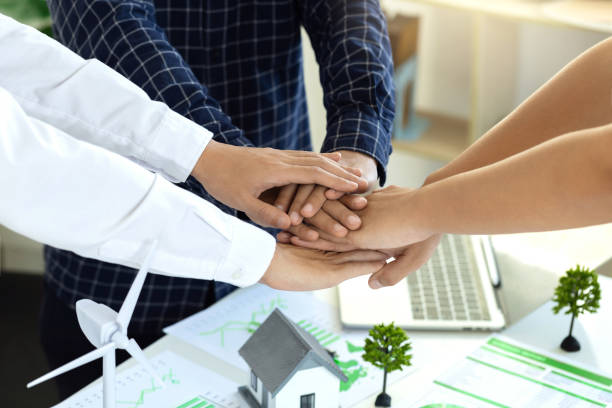 istock business people putting their hands together. Stack of hands. Unity and teamwork for ESG environmental social governance policy for modish business.Business cooperation for environmental protection. 2027284239