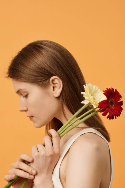 young woman with flowers - flower sparse single flower gerbera daisy ストックフォトと画像