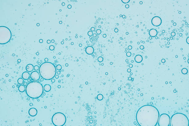 istock Oil and water bubbles background. Abstract face cleanser bubbles background. 2027308451