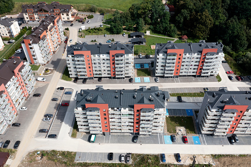 A new residential neighborhood with modern apartment buildings surrounded by green areas, aerial view.
