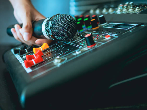 hand sound engineer  holding microphone on sound mixer in live broadcasting studio producer for sound record control system production and audio equipment and music instrument - recording studio sound recording equipment record interconnect imagens e fotografias de stock