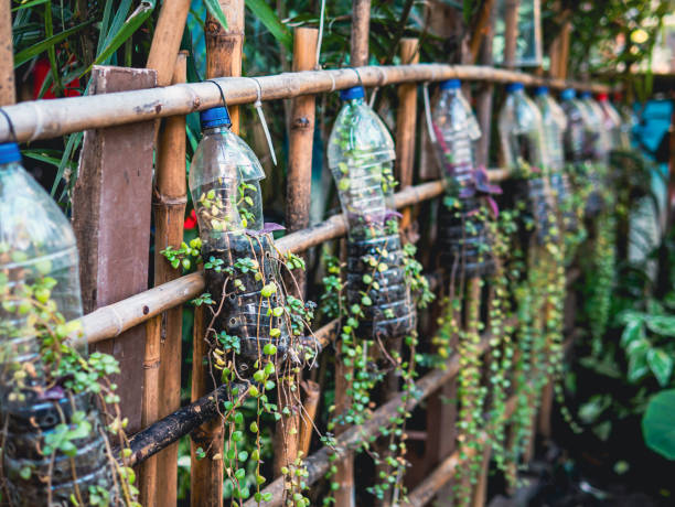 istock Creative ideas for making plant holders from recycled plastic bottles. These can be used to decorate your garden or home while reducing packaging waste. 2027318475