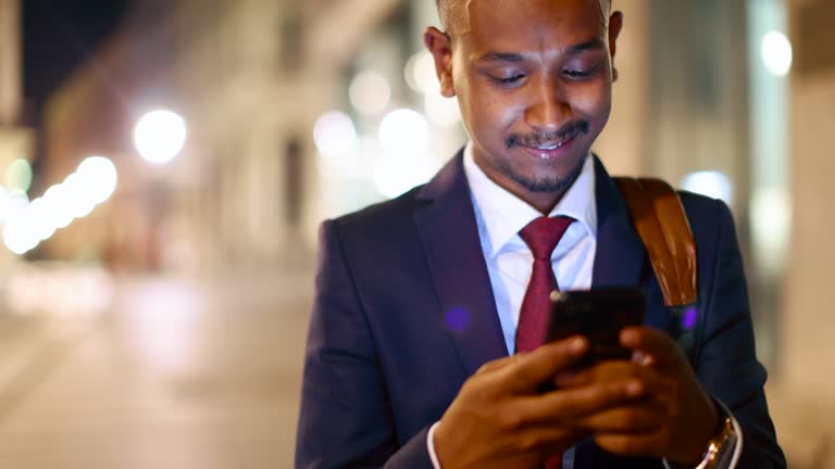 Indian/Pakistani businessman using mobile phone while commuting to/from work