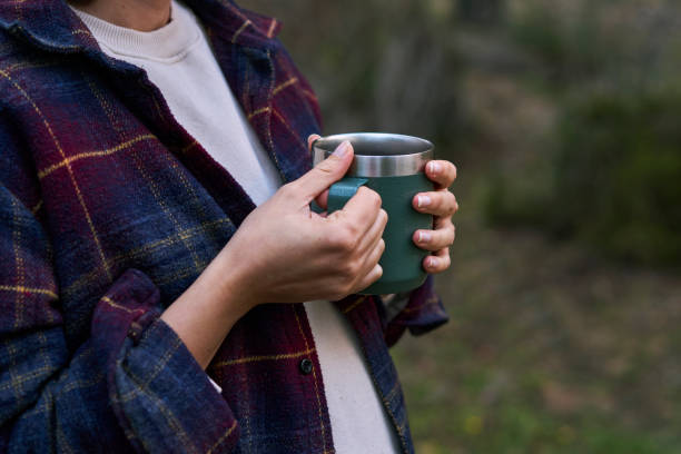 istock Beautiful Woman Drinking Coffee in Nature 2027340585