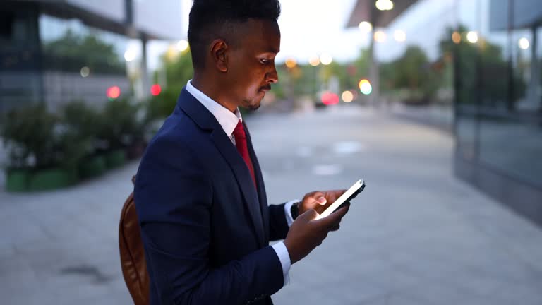 Indian/Pakistani businessman using mobile phone while commuting to/from work