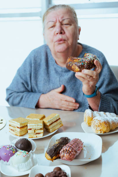 Elderly woman got heart attack while eating sweet food stock photo