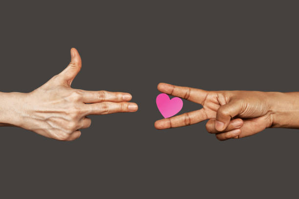 Stop War with Love, Peace Concept. Love always Win. a Finger Gun Gesture on left, right is a Victory Peace Hand Sign with Heart shape.World International Peace Day