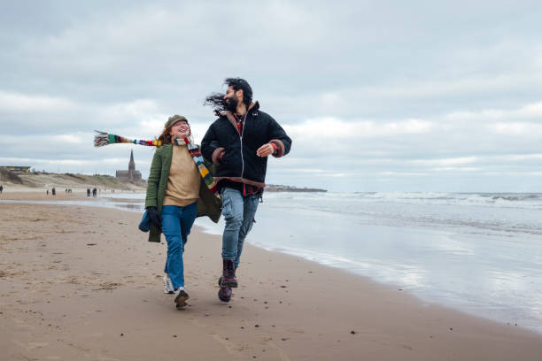 istock Friends Striding Along the Beach 2027397206