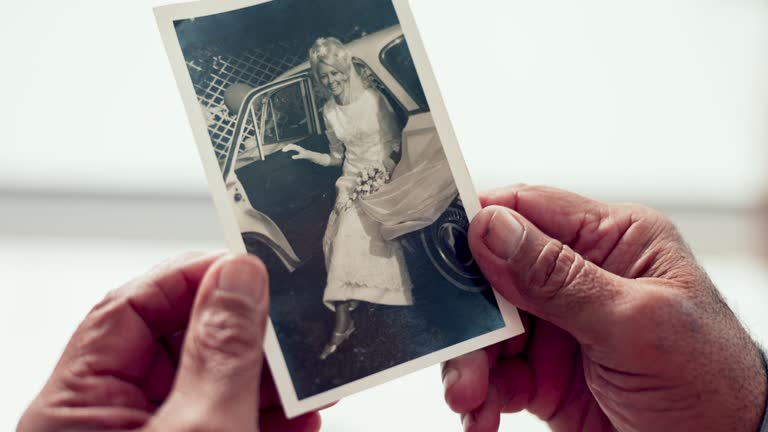 Hands, photograph and memory with a senior person thinking about the past while in a nursing home. History, vintage and retirement with an elderly adult holding a picture closeup to remember life