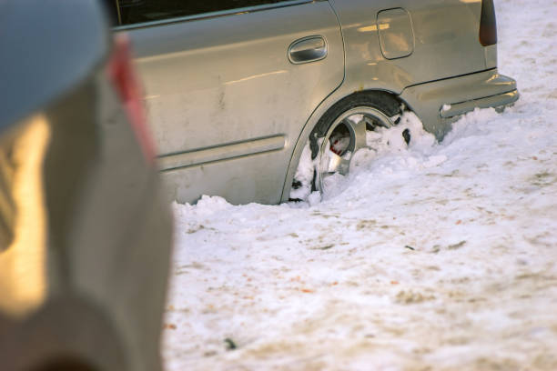 View of a car stuck in snow.